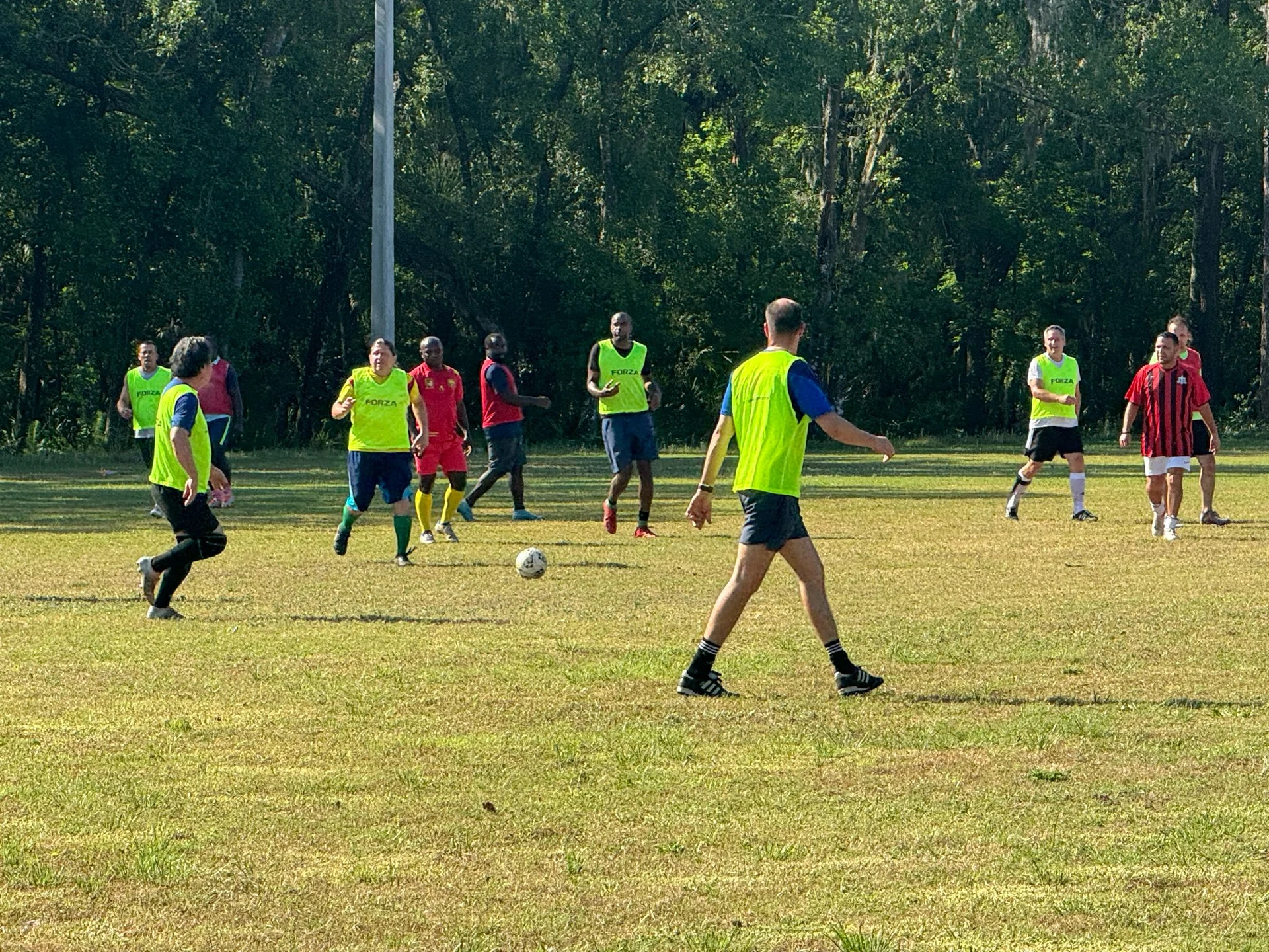 Football players practicing on a grass field