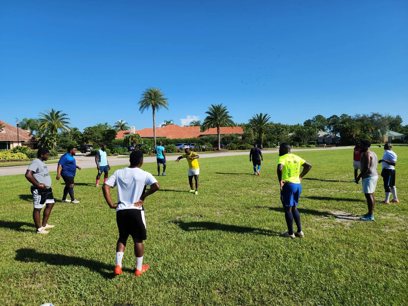 Football players practicing on a grass field