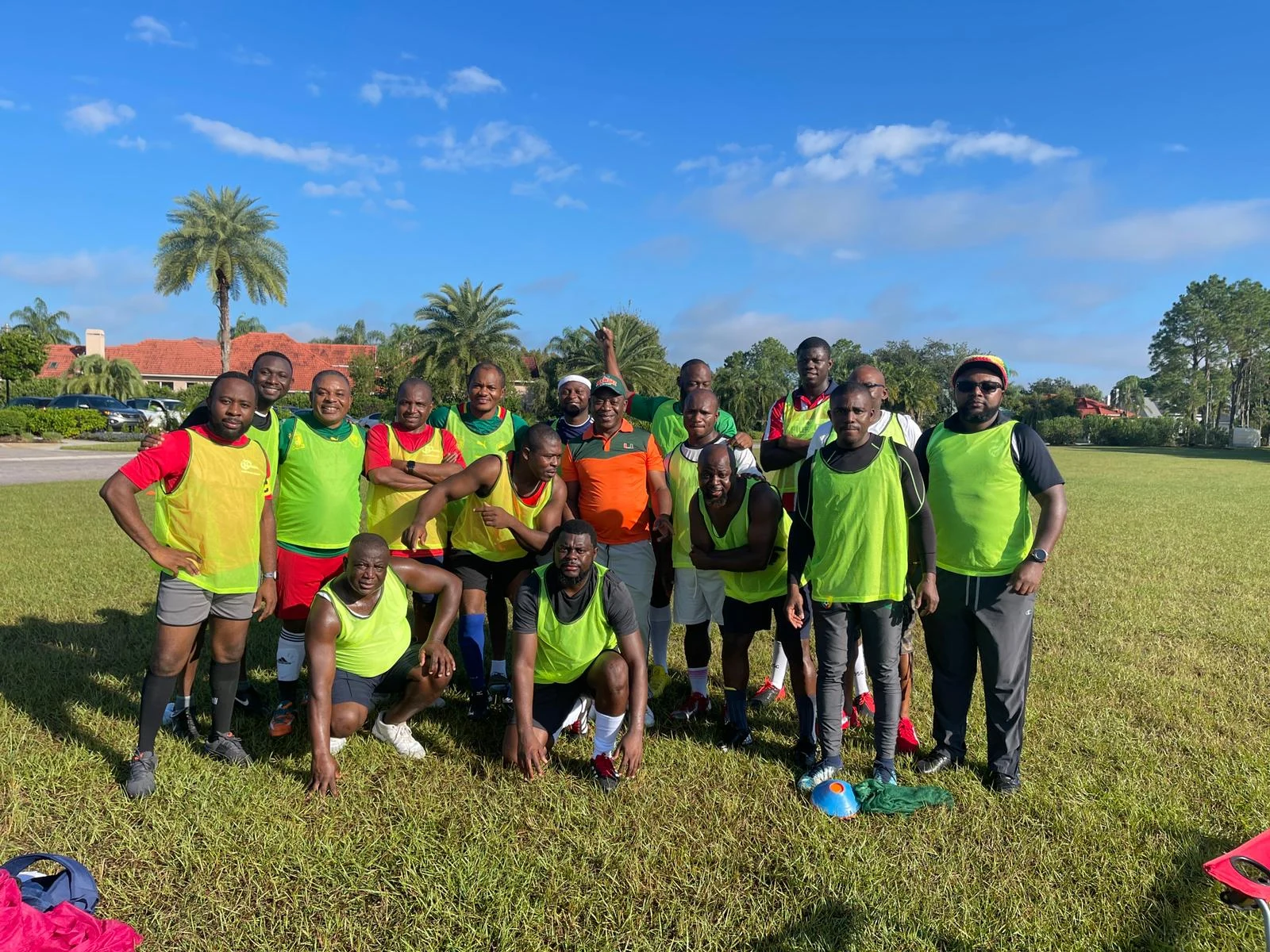 Practice group posing together in brightly colored training bibs
