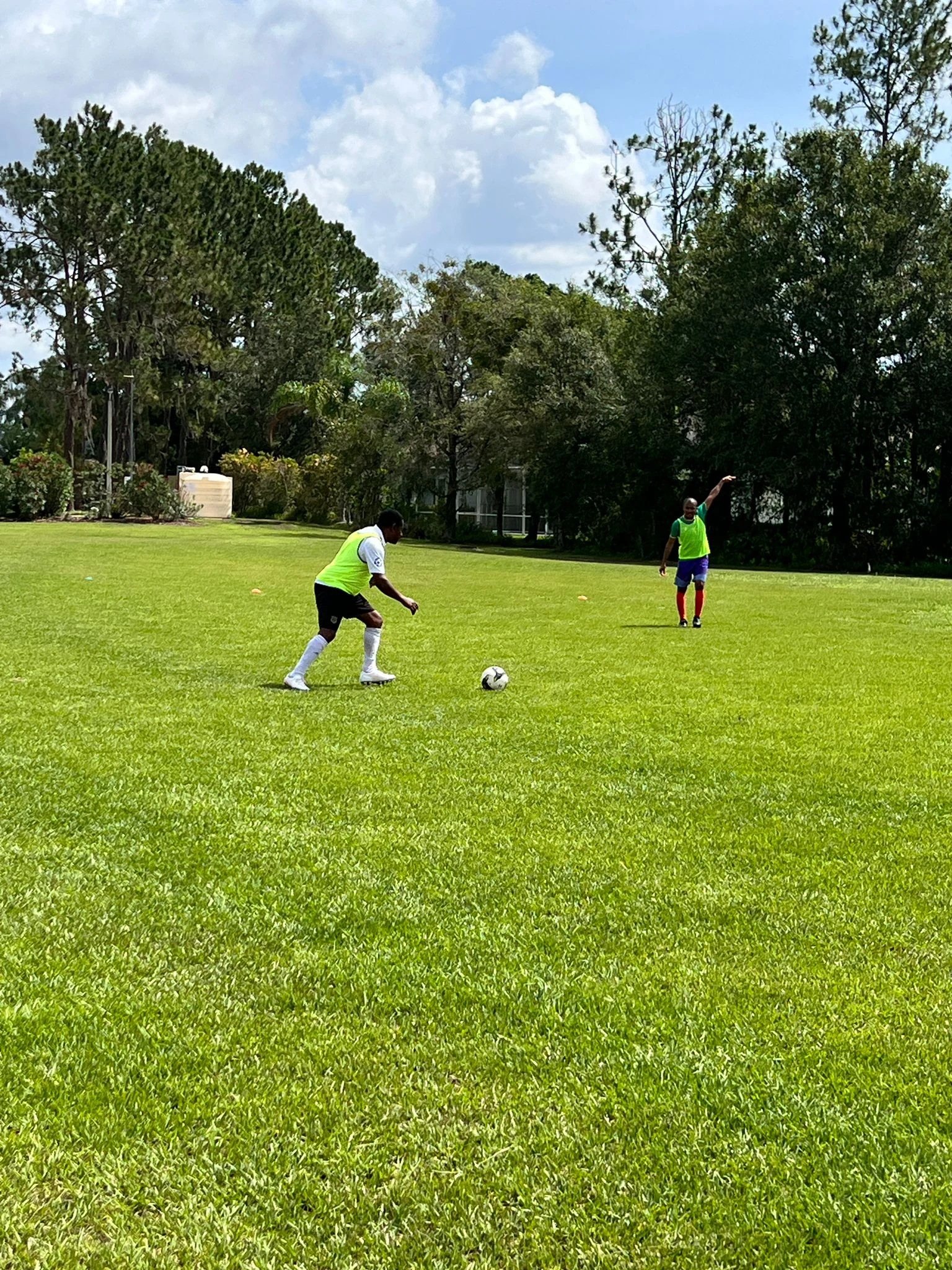 Football players practicing on a grass field