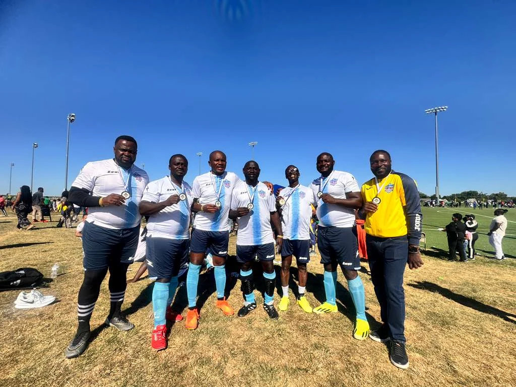 Football players posing in white and light blue kits