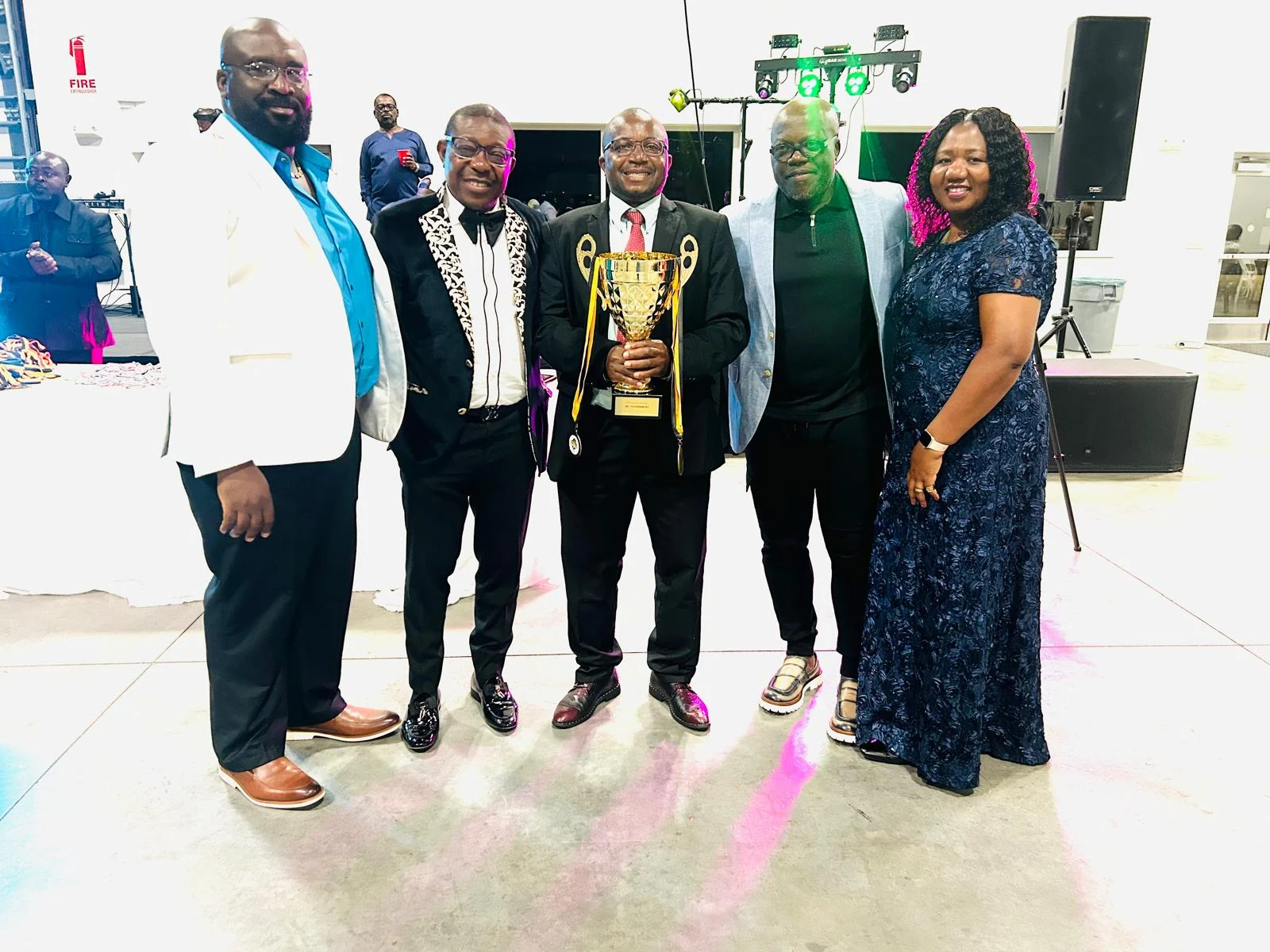 Club members celebrating with awards at a banquet