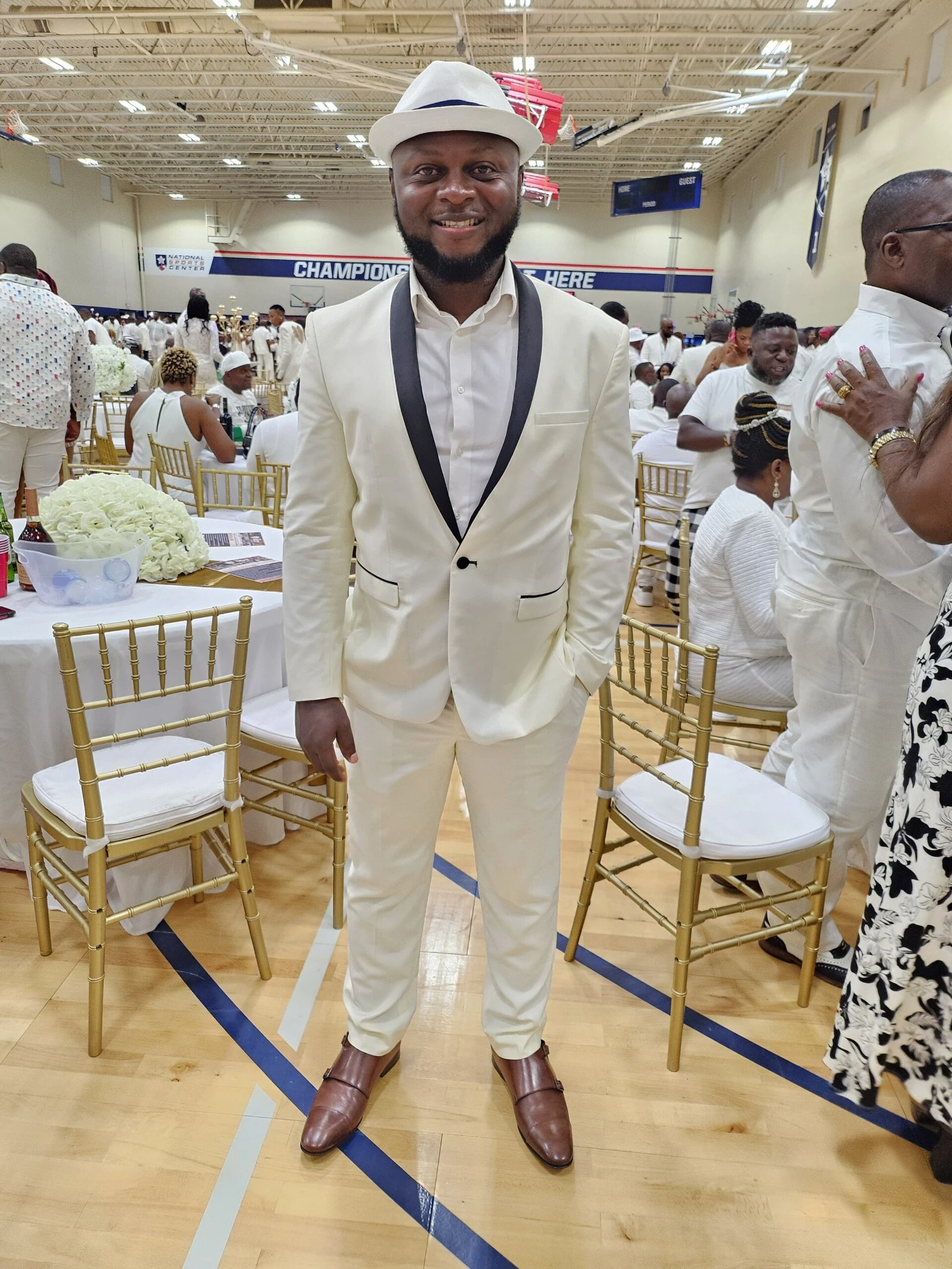 A guest dressed in white at the club celebration