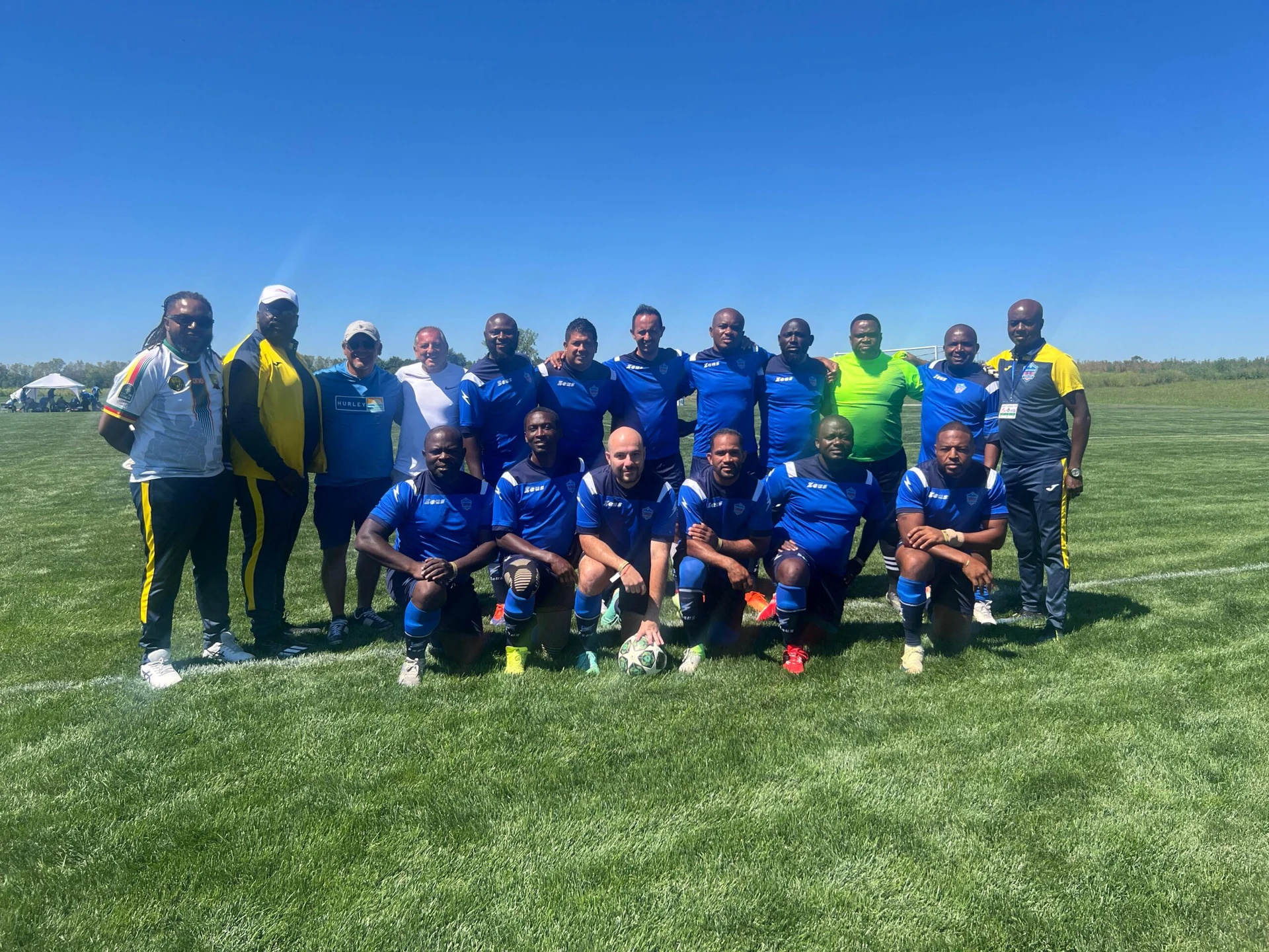 Football team posing together in blue kits