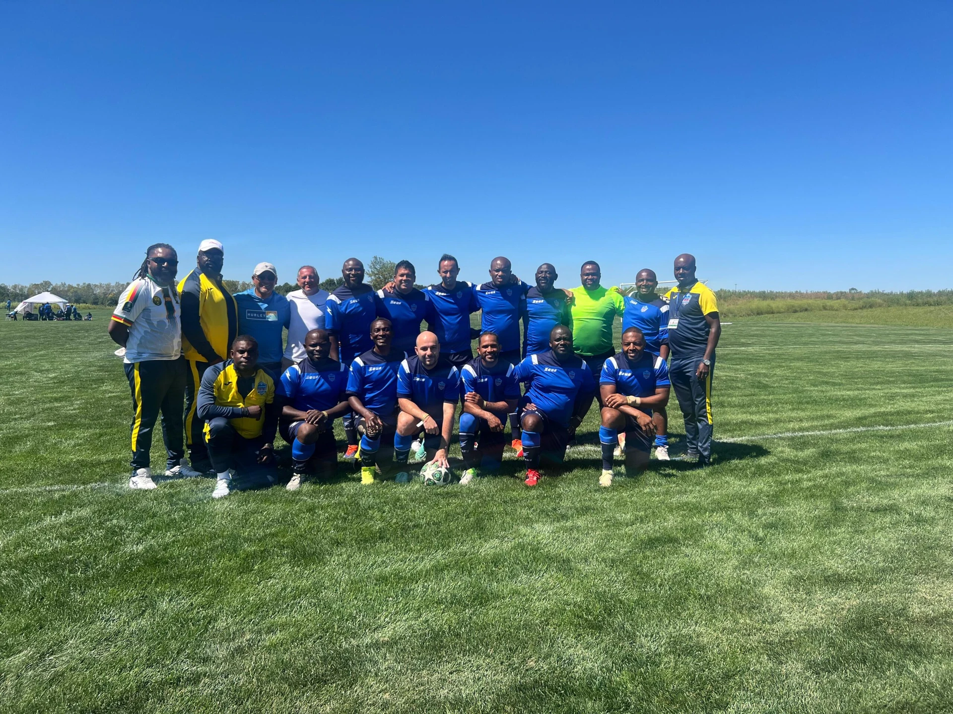 Football team posing together in blue kits
