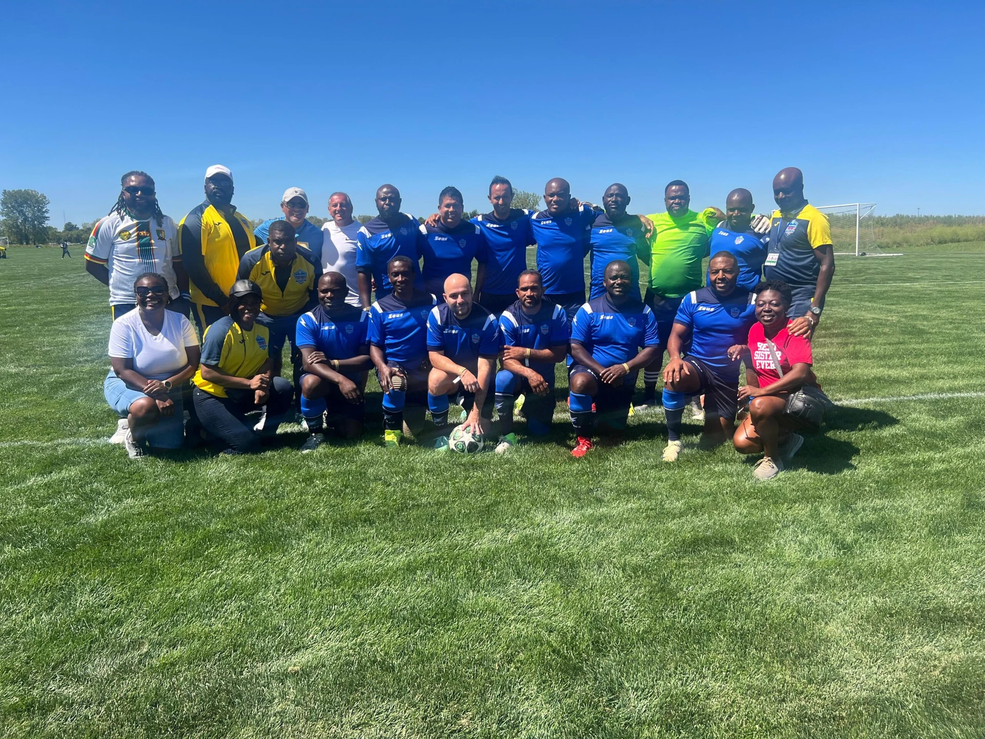 Football team posing together in blue kits
