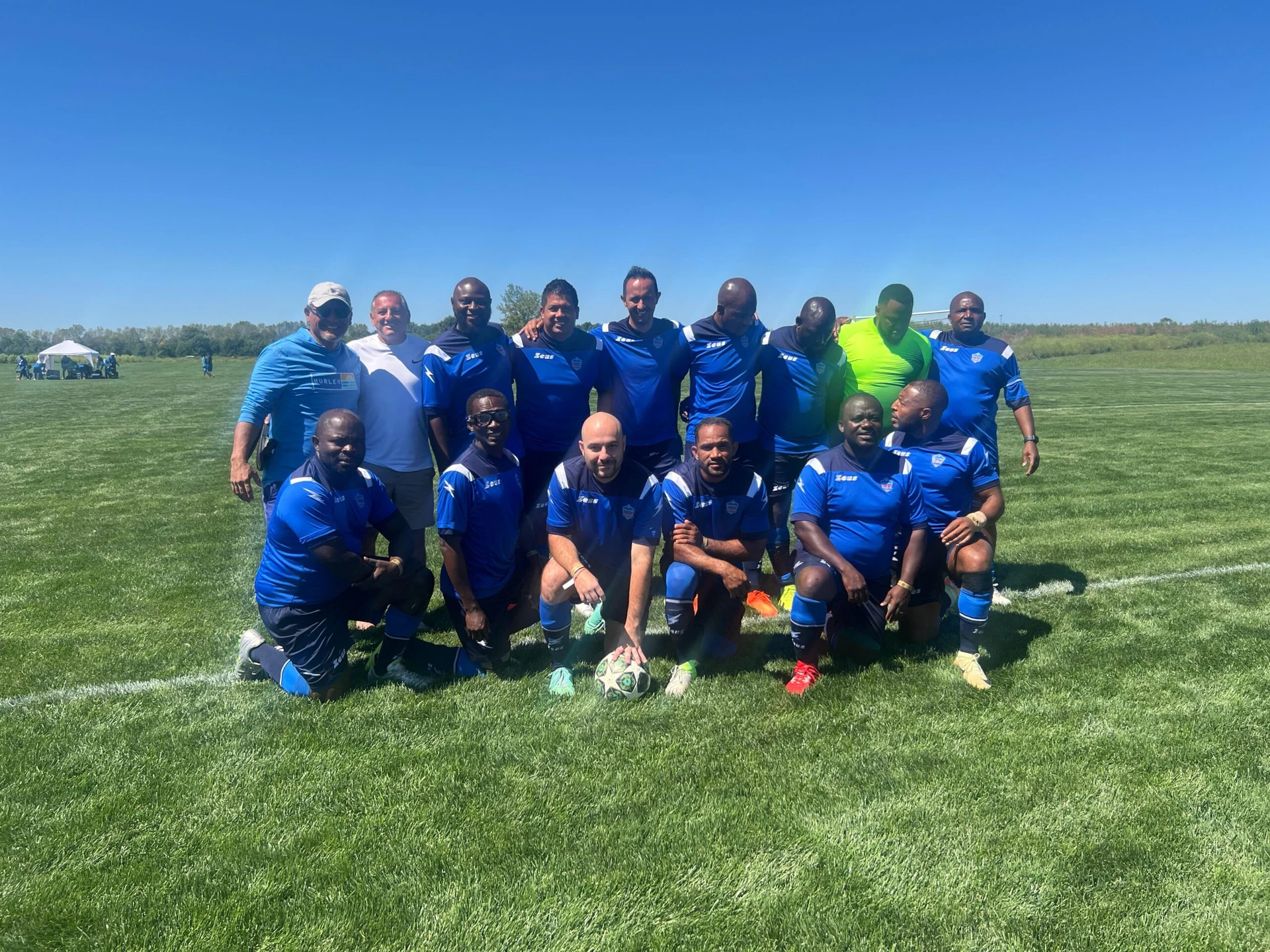 Football team posing together in blue kits