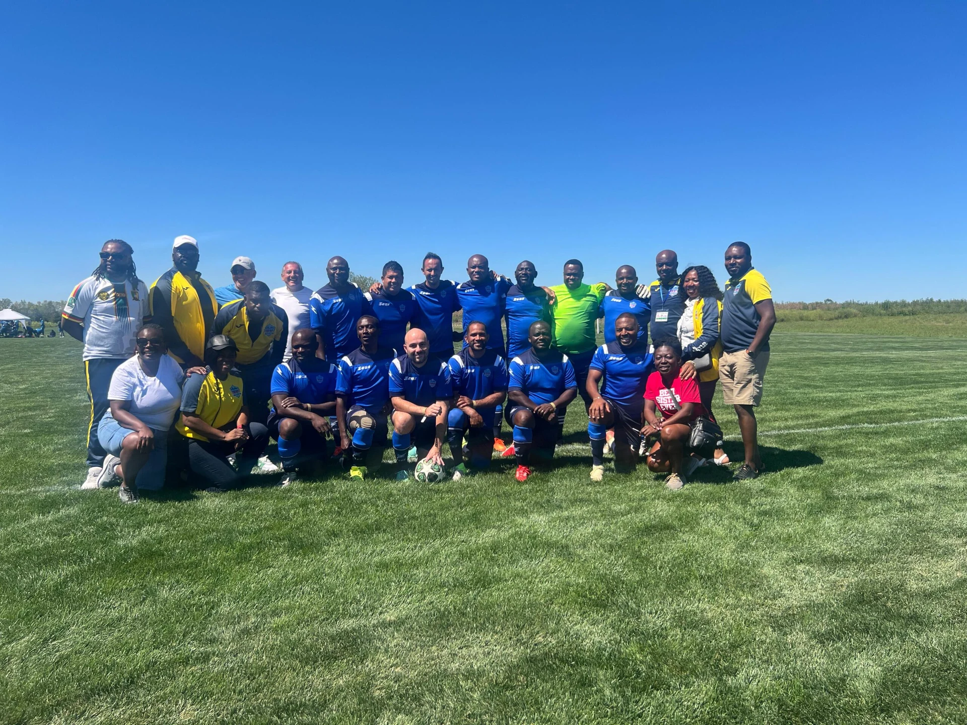 Football team posing together in blue kits