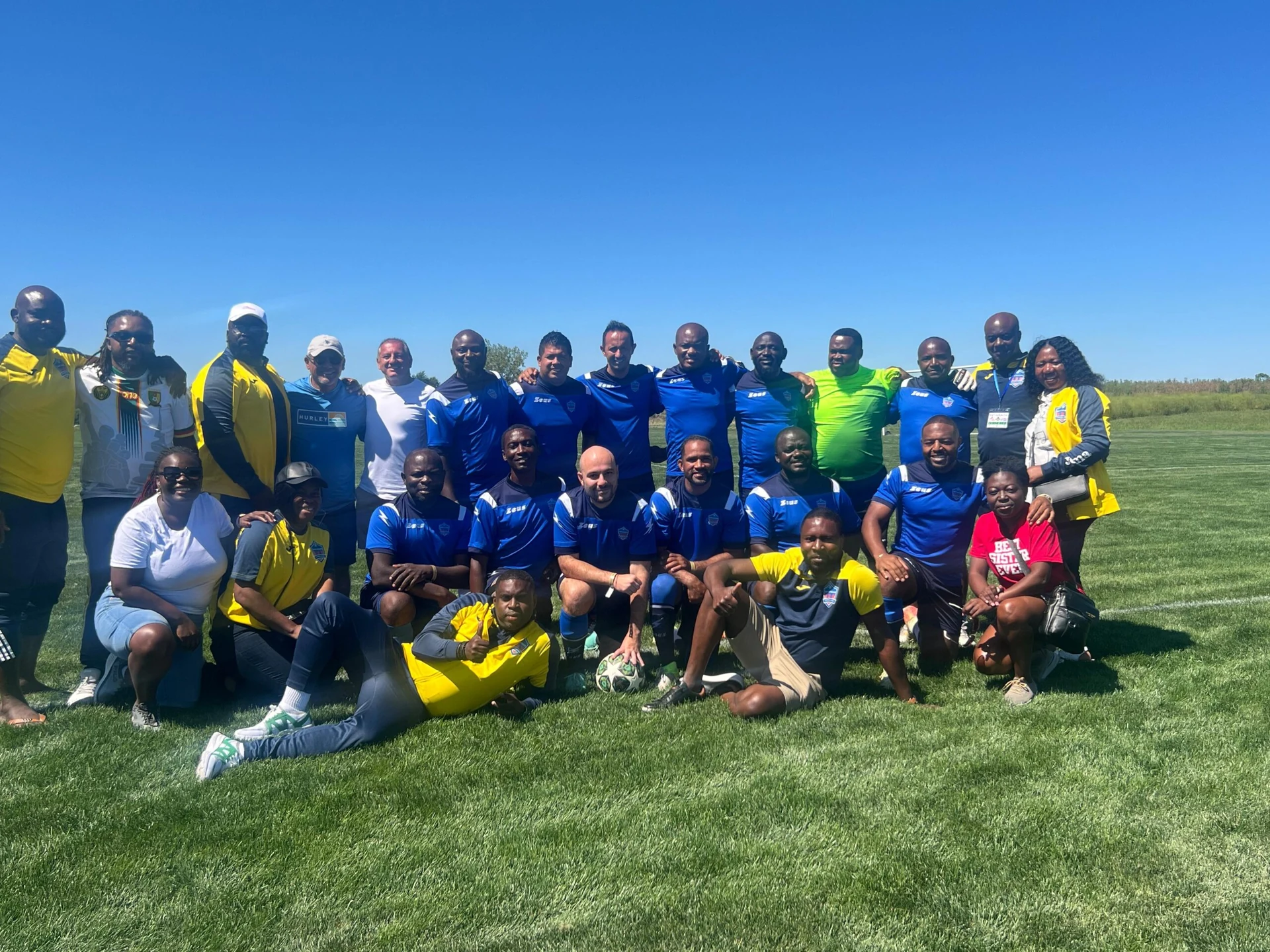 Football team posing together in blue kits
