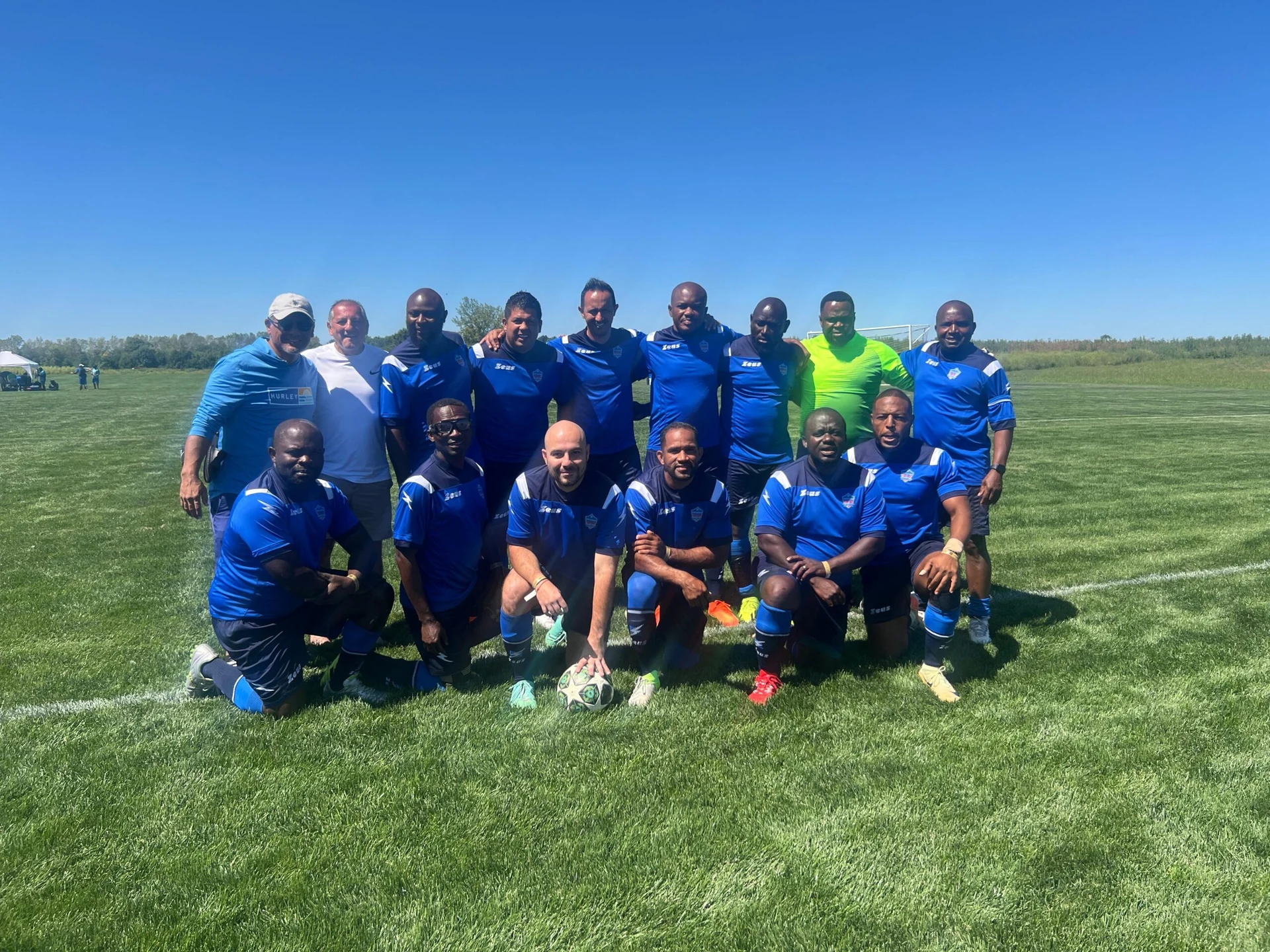 Football team posing together in blue kits