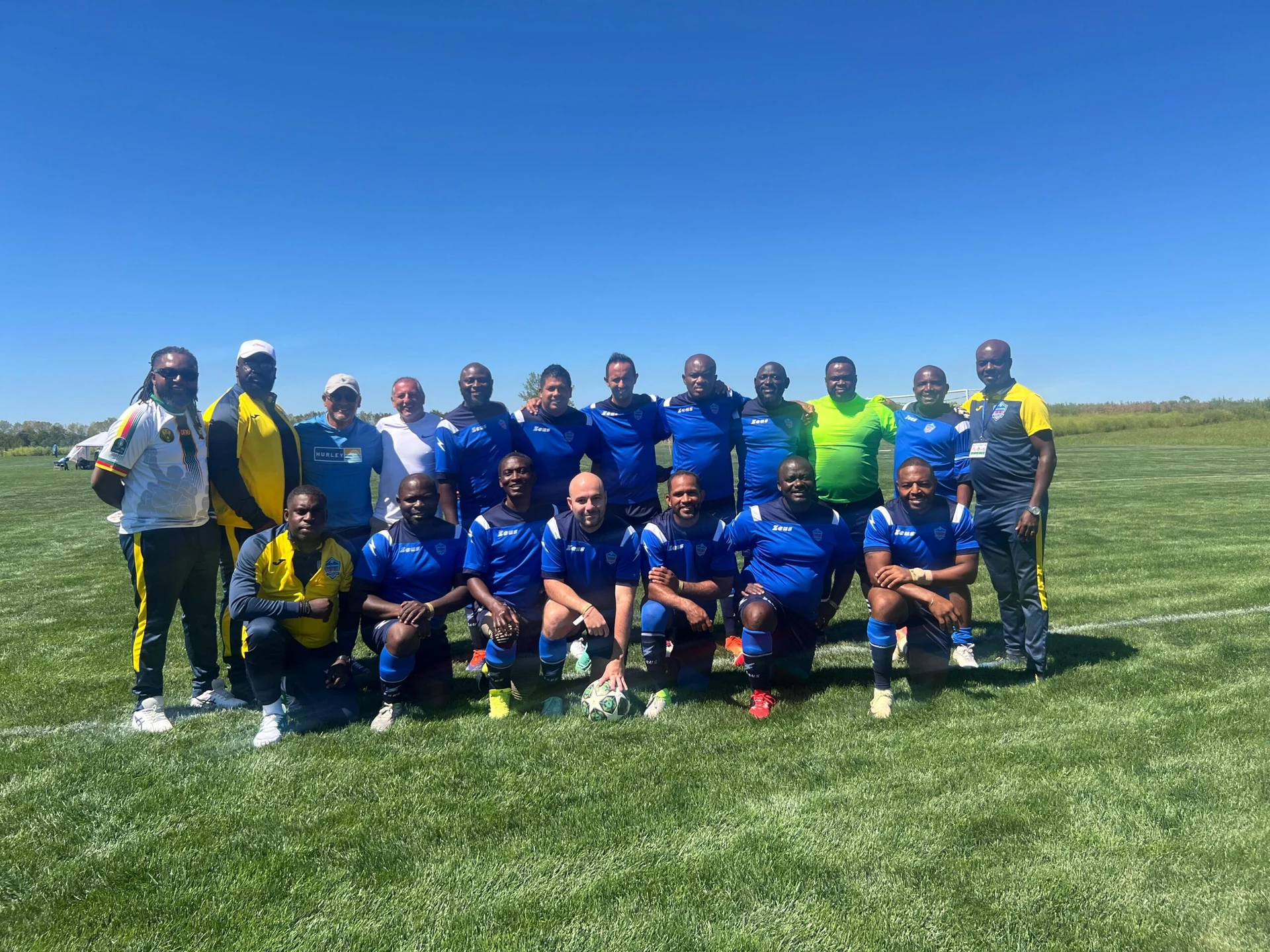 Football team posing together in blue kits