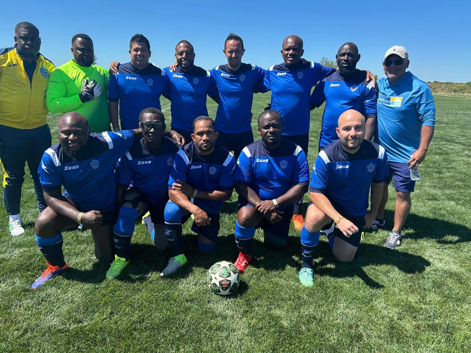 Football team posing together in blue kits