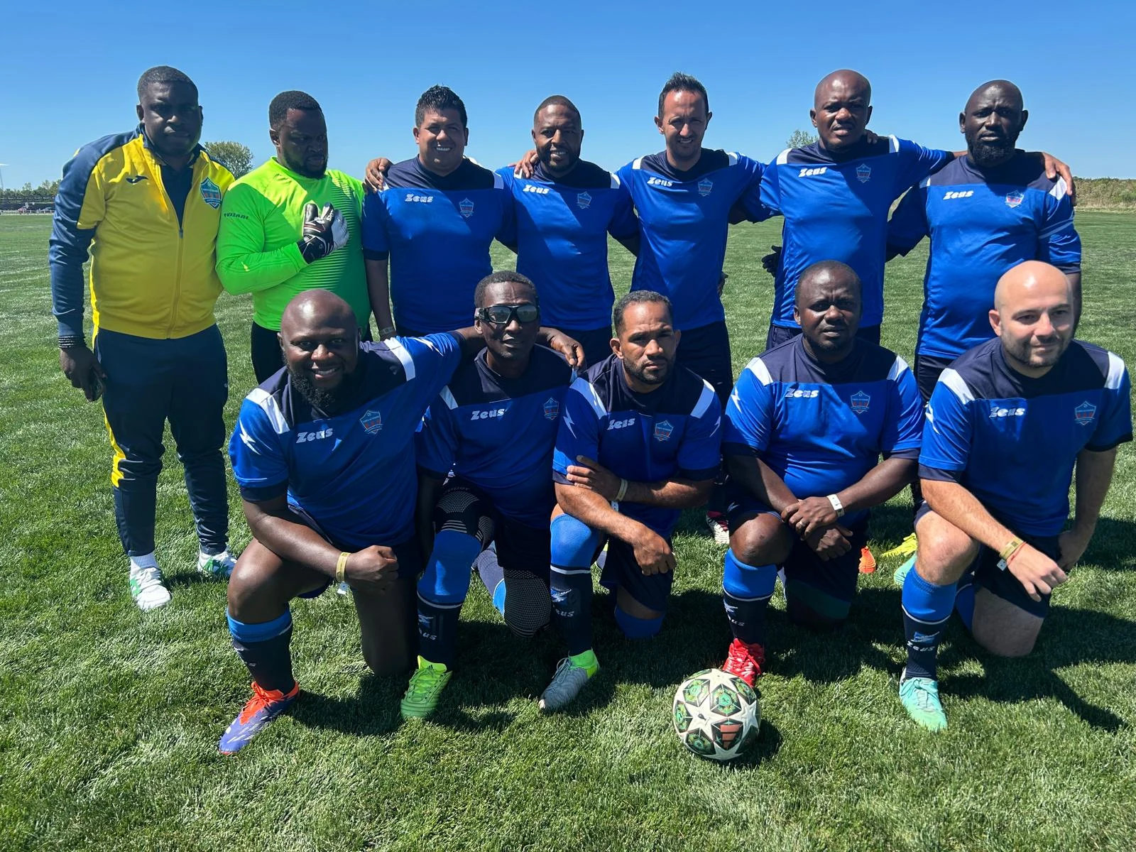 Football team posing together in blue kits