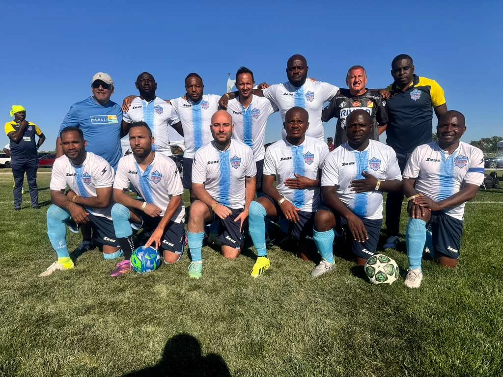 Football players posing in white and light blue kits