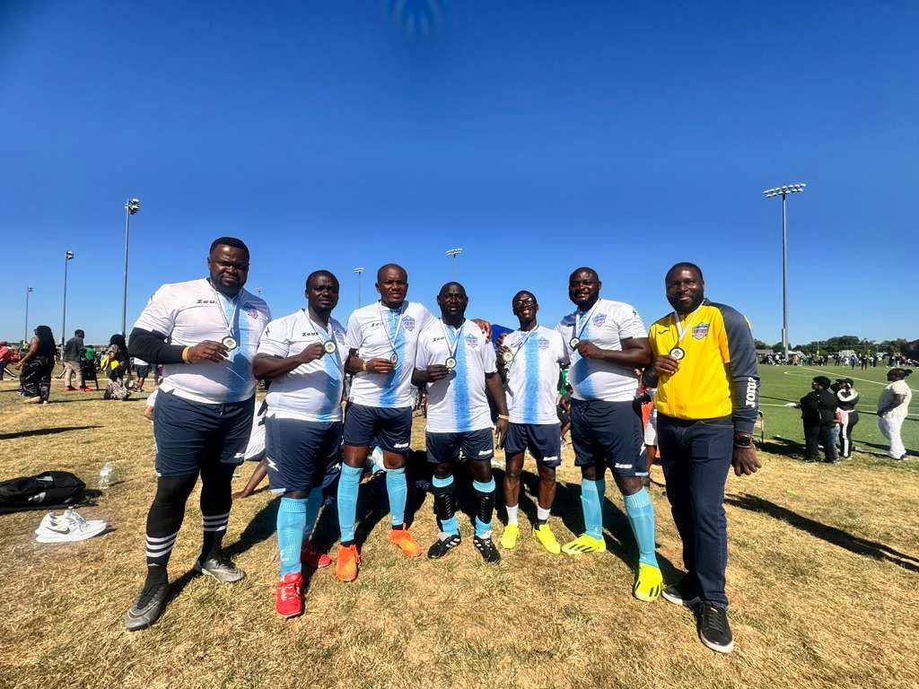 Football players posing in white and light blue kits
