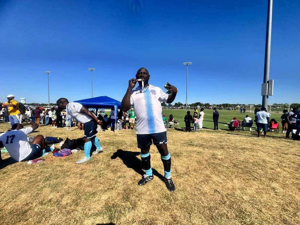 A player in a white and light blue kit standing on the field