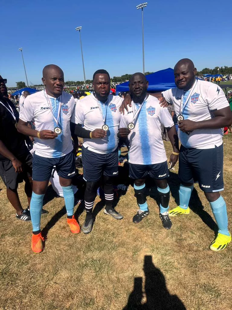 Football players posing in white and light blue kits