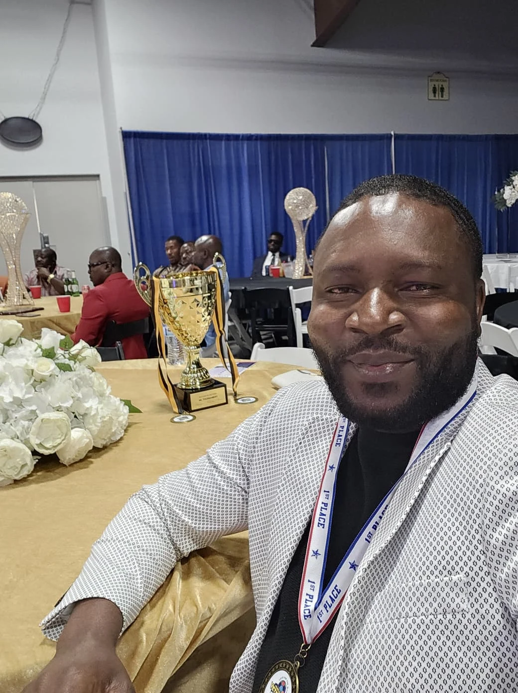 Club member wearing a medal at a banquet